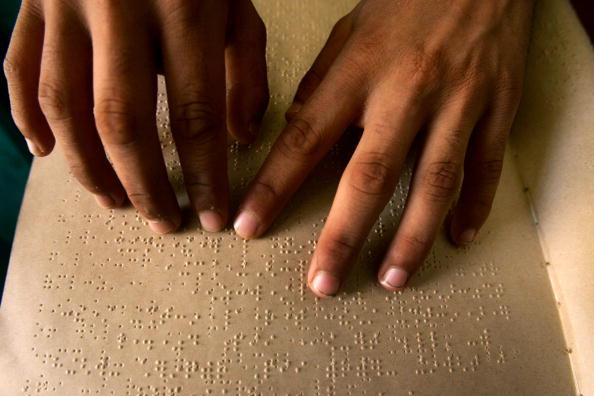 Image of student reading a braille book