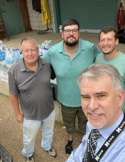 Superintendent Dr. Jeremy Stinson takes a selfie with Maintenance Director Bud Pace and members of First Presbyterian Church of Jackson, Joshua Hollingsworth and Neal Terry to say thanks for the first of many generous bottle water donations.