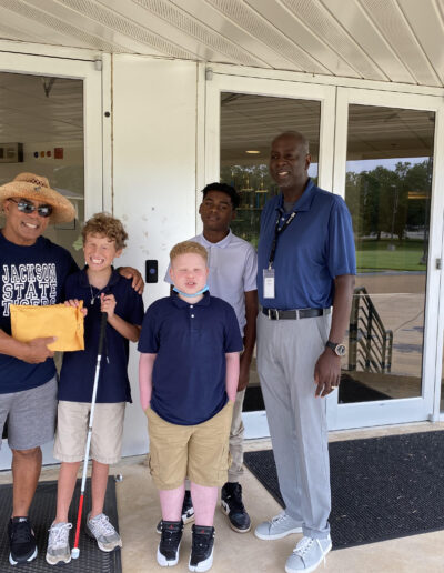 Mr. Randal Lewis with MSB students and Mr. Spann (MSB principal), presents monetary donation to the school. This donation is made annually to the school by Mr. Lewis.